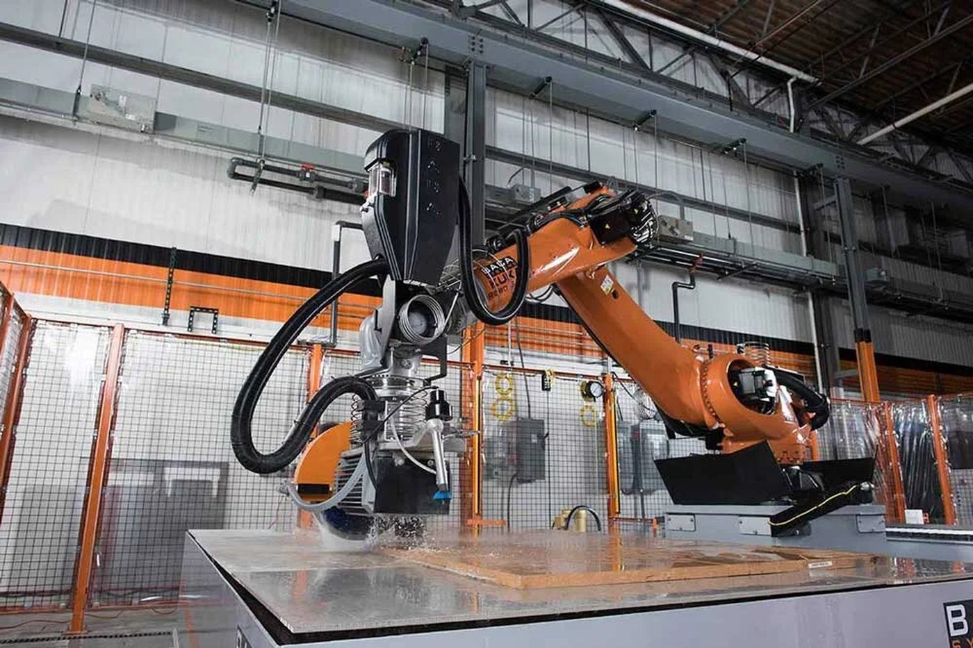 Robotic waterjet cutting a porcelain panel at Surface Providers in Alpharetta
